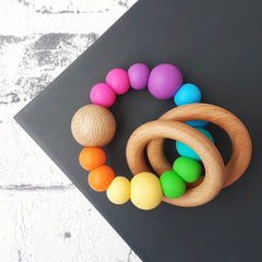Newborn teether and montessori toys. Handmade with BPA-free silicone and natural beech wood timber teething rings. Dreamer teething toy by Bowerbird Creations. Made in Australia. Bright rainbow.