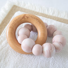 Teething Toy silicone and beech wood. Handmade in Australia by Bowerbird Creations. Pink Marble Halo Teether Toy on white background.