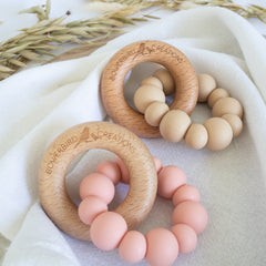 Handmade teething toy for babies, made from non-toxic silicone and beech wood. Peach and beige. Made in Australia by Bowerbird Creations.