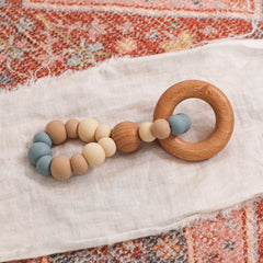 Teething toy handmade in Australia by Bowerbird Creations. Silicone and Beech wood. Neutral blue and beige.