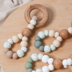 Teething toys infinity. Handmade from silicone and beech wood by Bowerbird Creations. Made in Australia. Beige, Sage, Eucalyptus. Close up photo.
