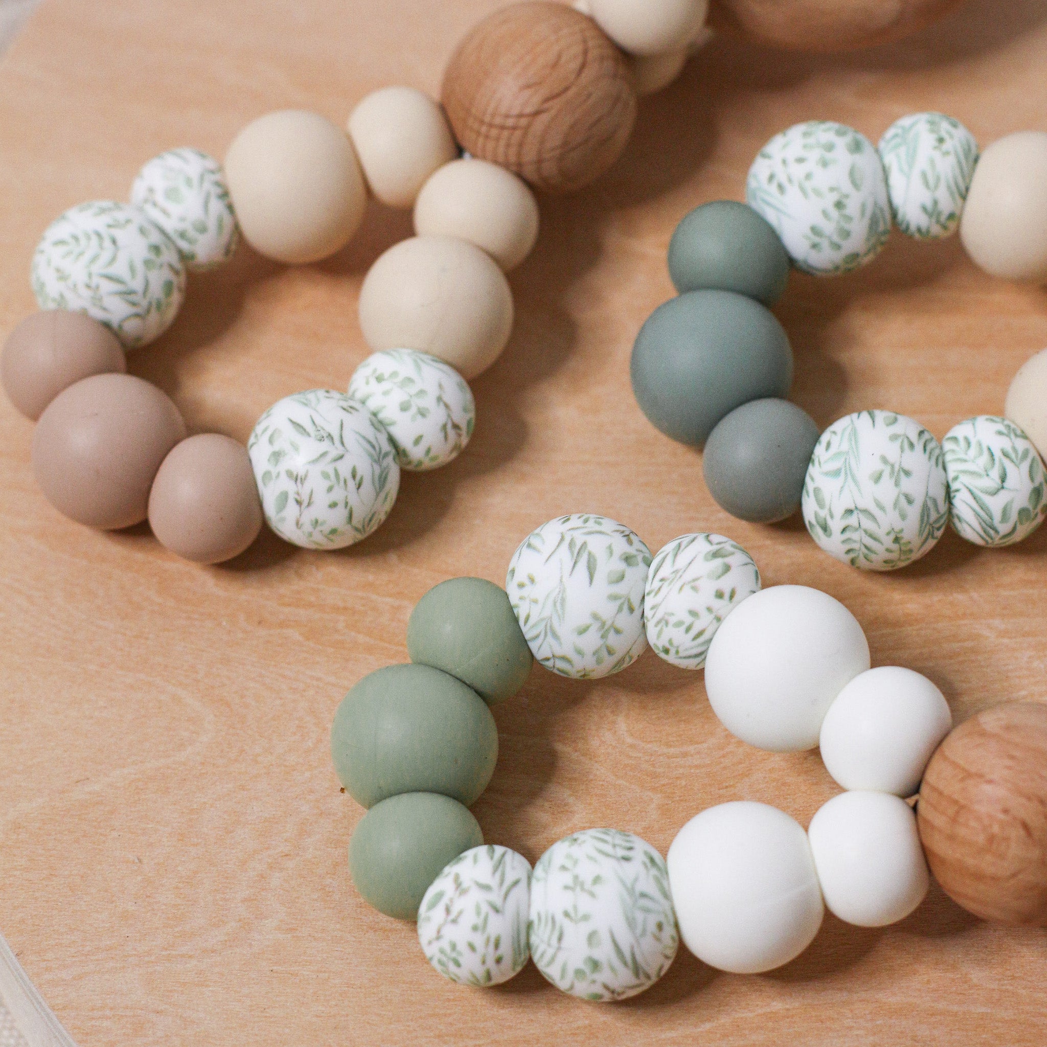 Teething toys infinity. Handmade from silicone and beech wood by Bowerbird Creations. Made in Australia. Beige, Sage, Eucalyptus.
