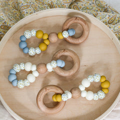 Handmade teething toys. Made in Australia from BPA-free silicone and beech wood. Non-toxic and safe. Bowerbird Creations. Blue, cream, mustard and wattle.