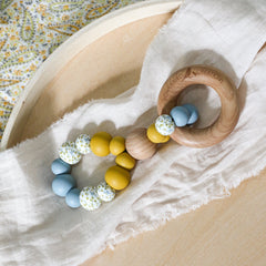 Handmade teething toy. Made in Australia from BPA-free silicone and beech wood. Non-toxic and safe. Bowerbird Creations. Blue, mustard and wattle.
