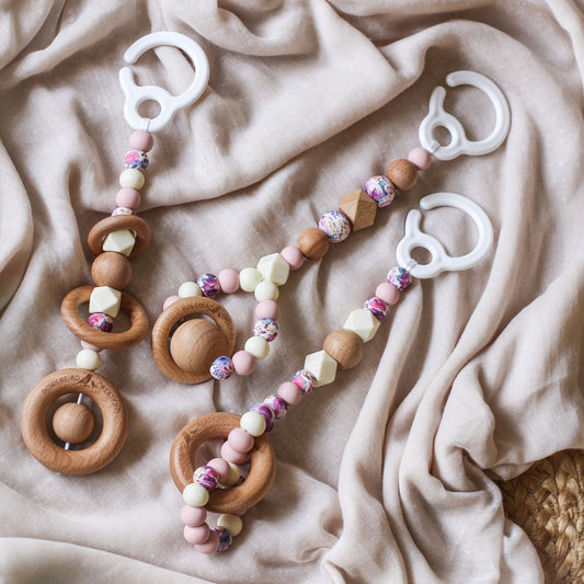 3 handmade silicone and wood baby play gym toys in pink, floral and cream