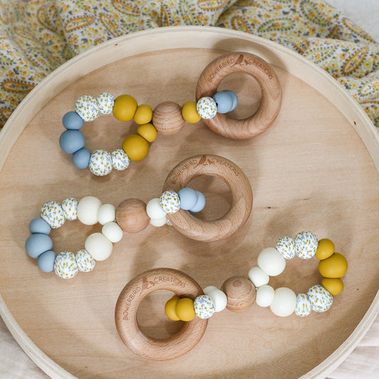Handmade teething toys. Made in Australia from BPA-free silicone and beech wood. Non-toxic and safe. Bowerbird Creations. Blue, cream, mustard and wattle. 