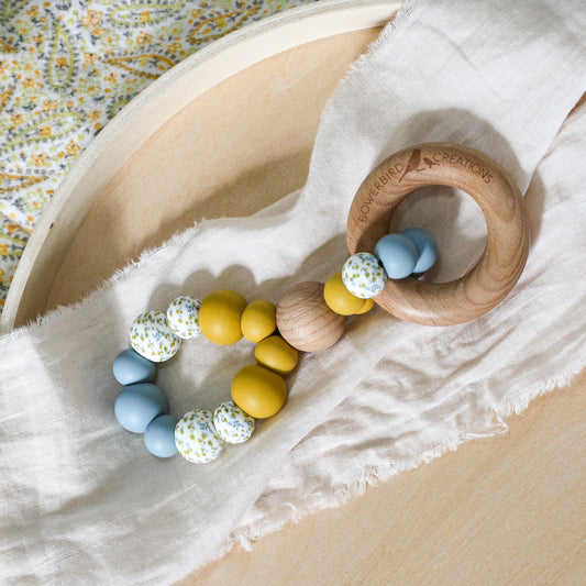 Handmade teething toy. Made in Australia from BPA-free silicone and beech wood. Non-toxic and safe. Bowerbird Creations. Blue, mustard and wattle. 