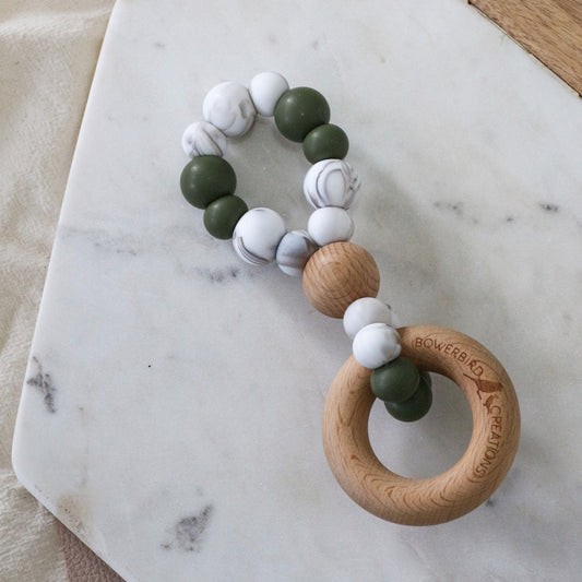 Infinity teething toy in marble and olive. Handmade in Australia by Bowerbird Creations from BPA-free silicone and beech wood timber teething ring. Non-toxic and safe. 