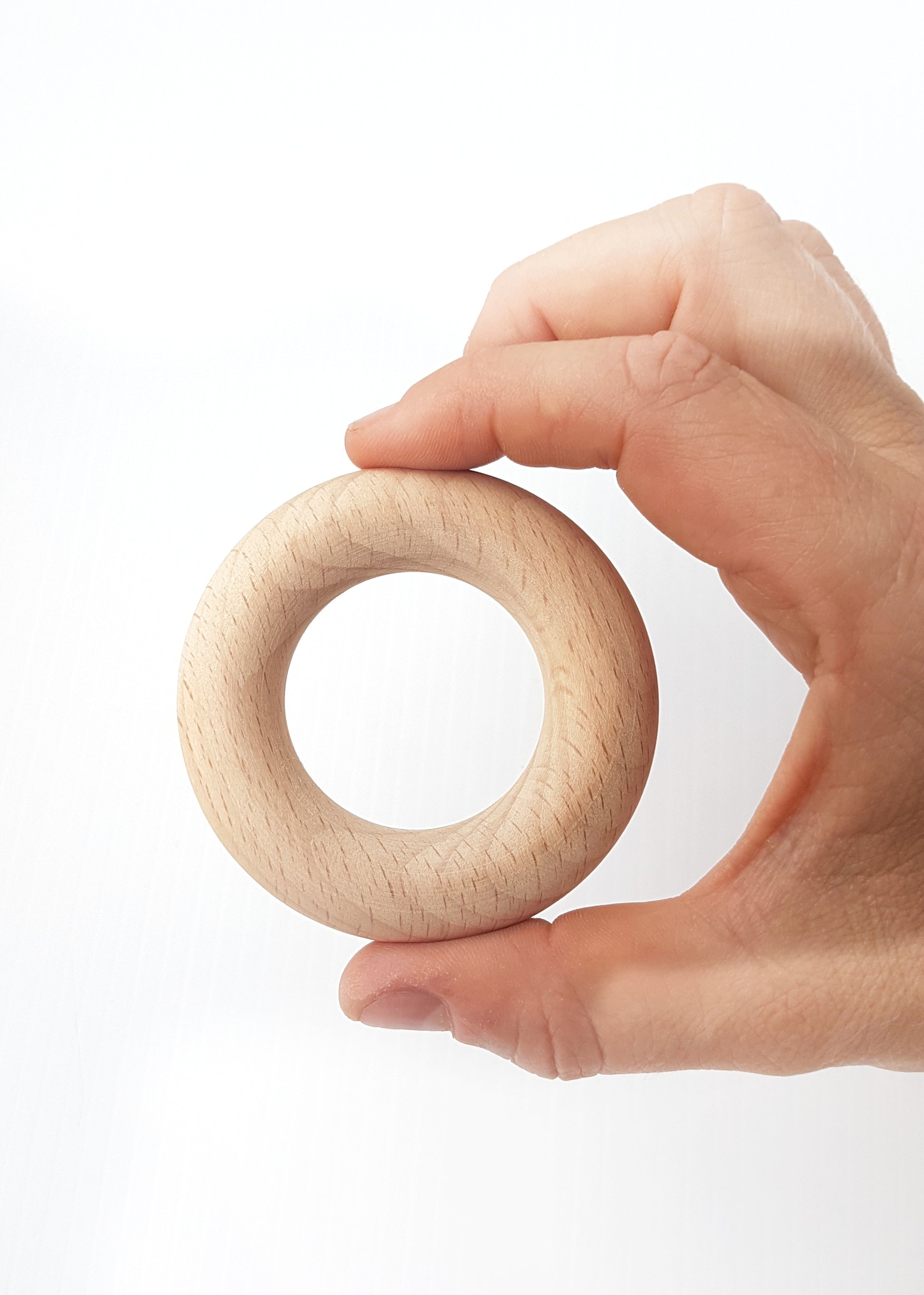 Natural beech timber rings for teething babies polished with organic beeswax and olive oil or coconut oil to soothe sore gums.