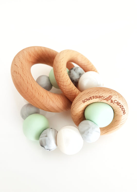 Silicone teething toy for baby with 3 wooden rings. Mint, white, marble.