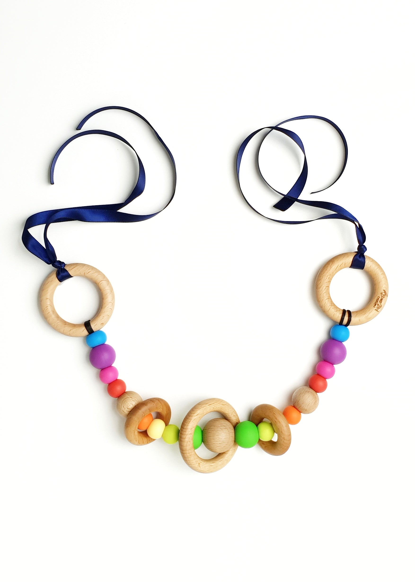 Rainbow pram garland. Handmade from non-toxic silicone and natural beech timber.