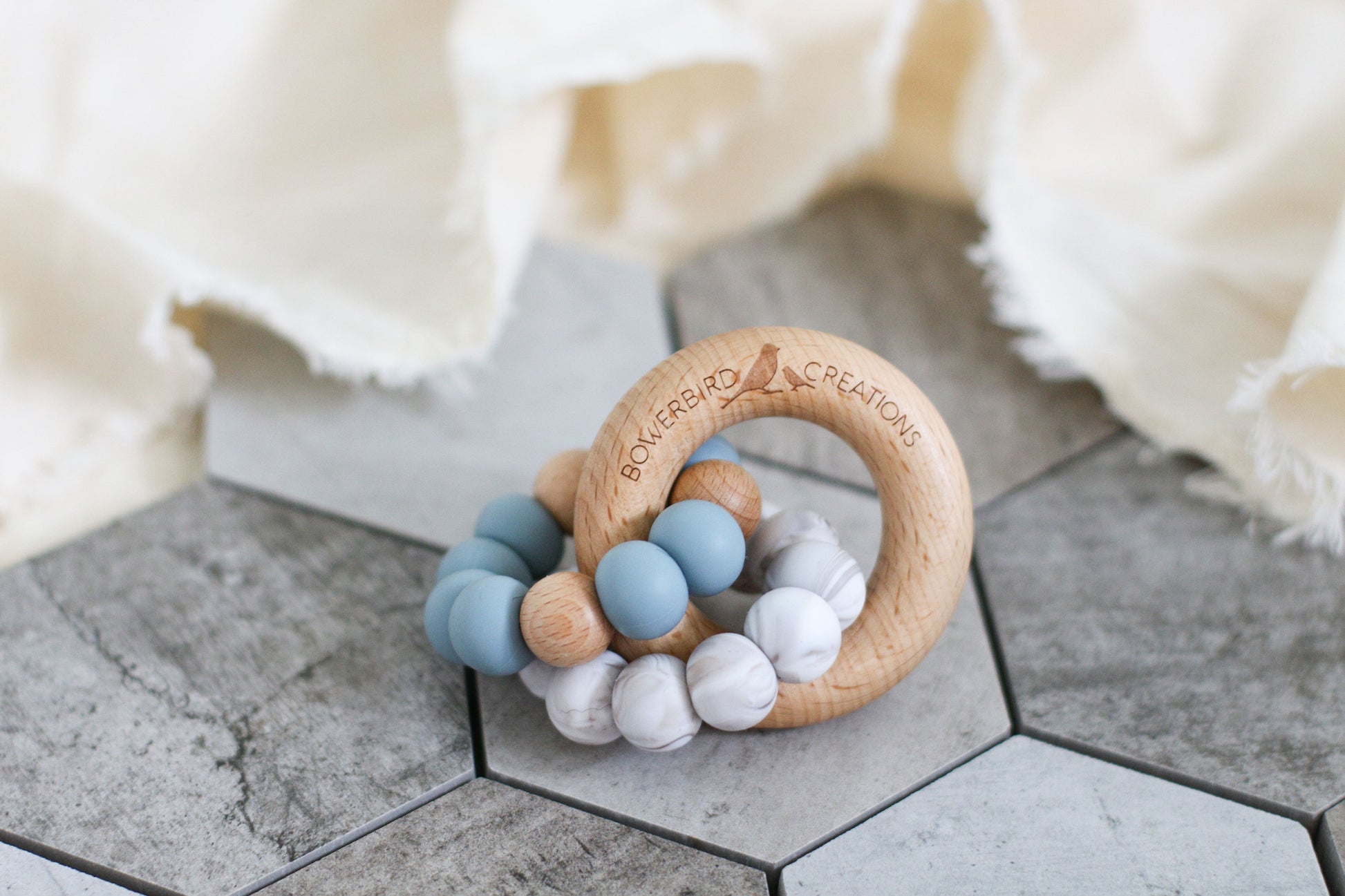 Wonderous teething toy. Baby chew toy handmade with silicone and natural beech wood. Blue, marble.