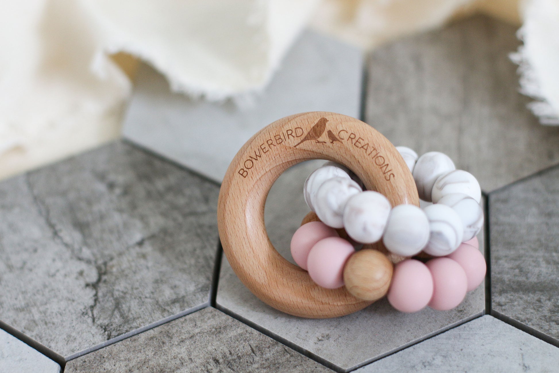 Wonderous teething toy. Baby chew toy handmade with silicone and natural beech wood. Pink, marble.