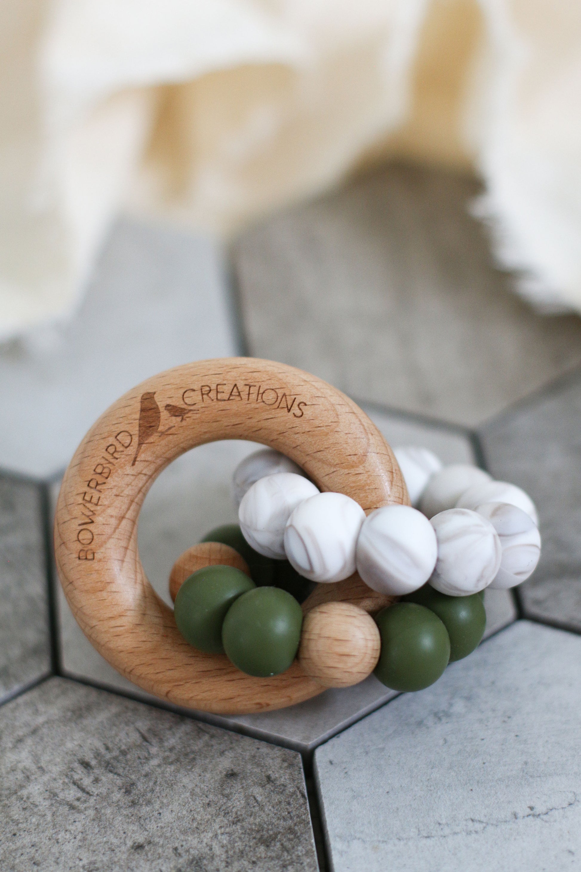 Wonderous teething toy. Baby chew toy handmade with silicone and natural beech wood. Green, marble.